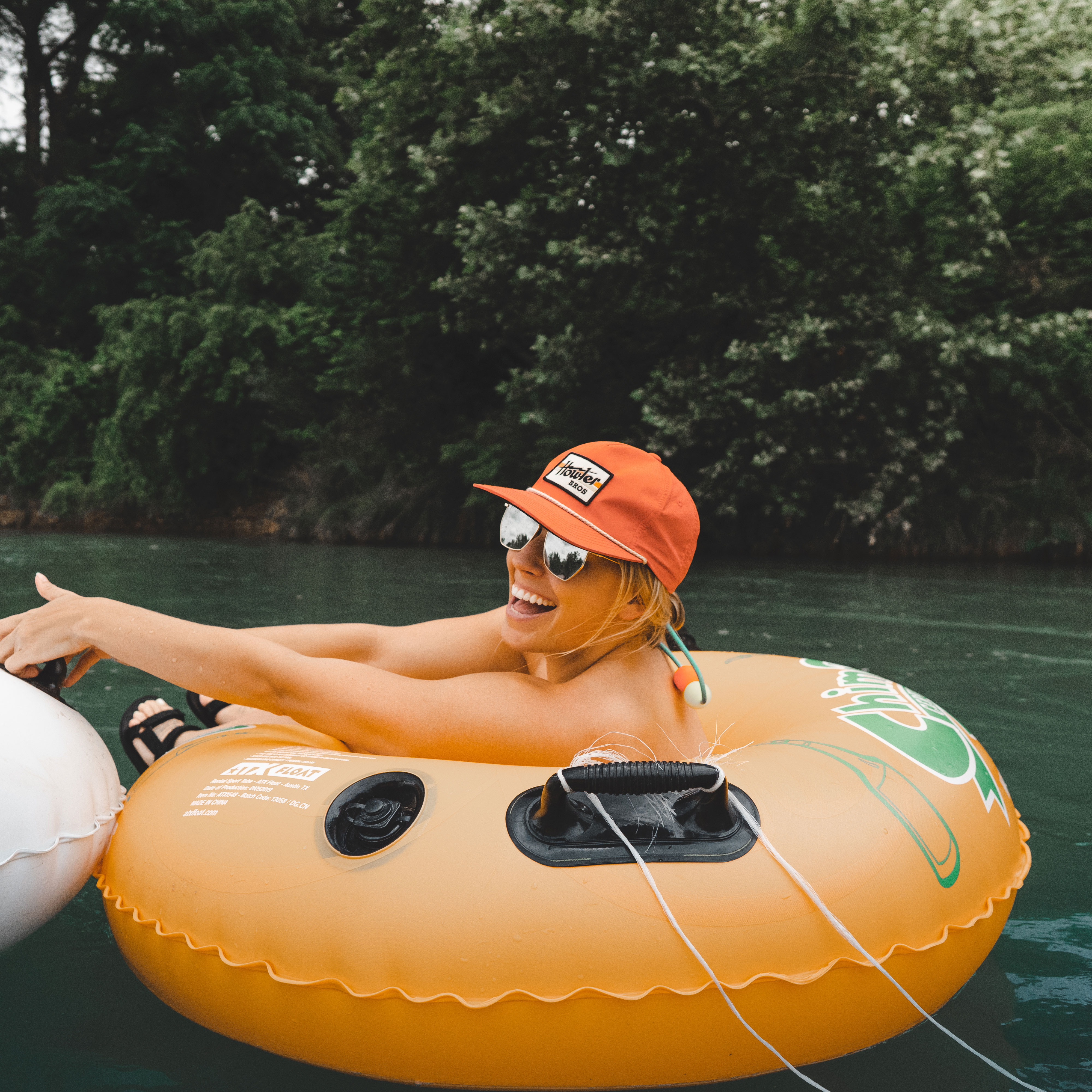 Girl in a river tube smiling